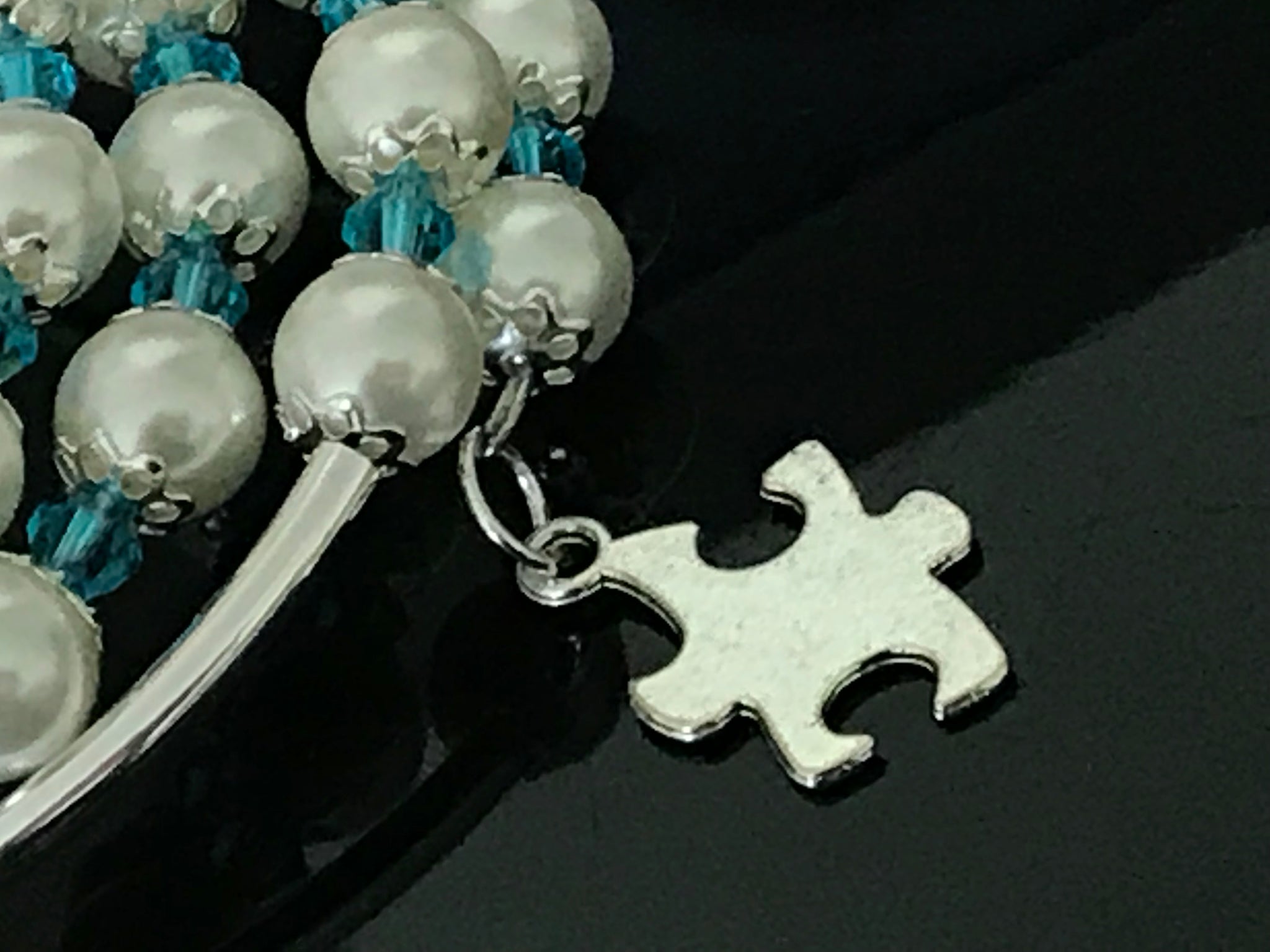 Autism awareness white glass pearls, Swarovski with silver noodle beads on a memory wire bracelet