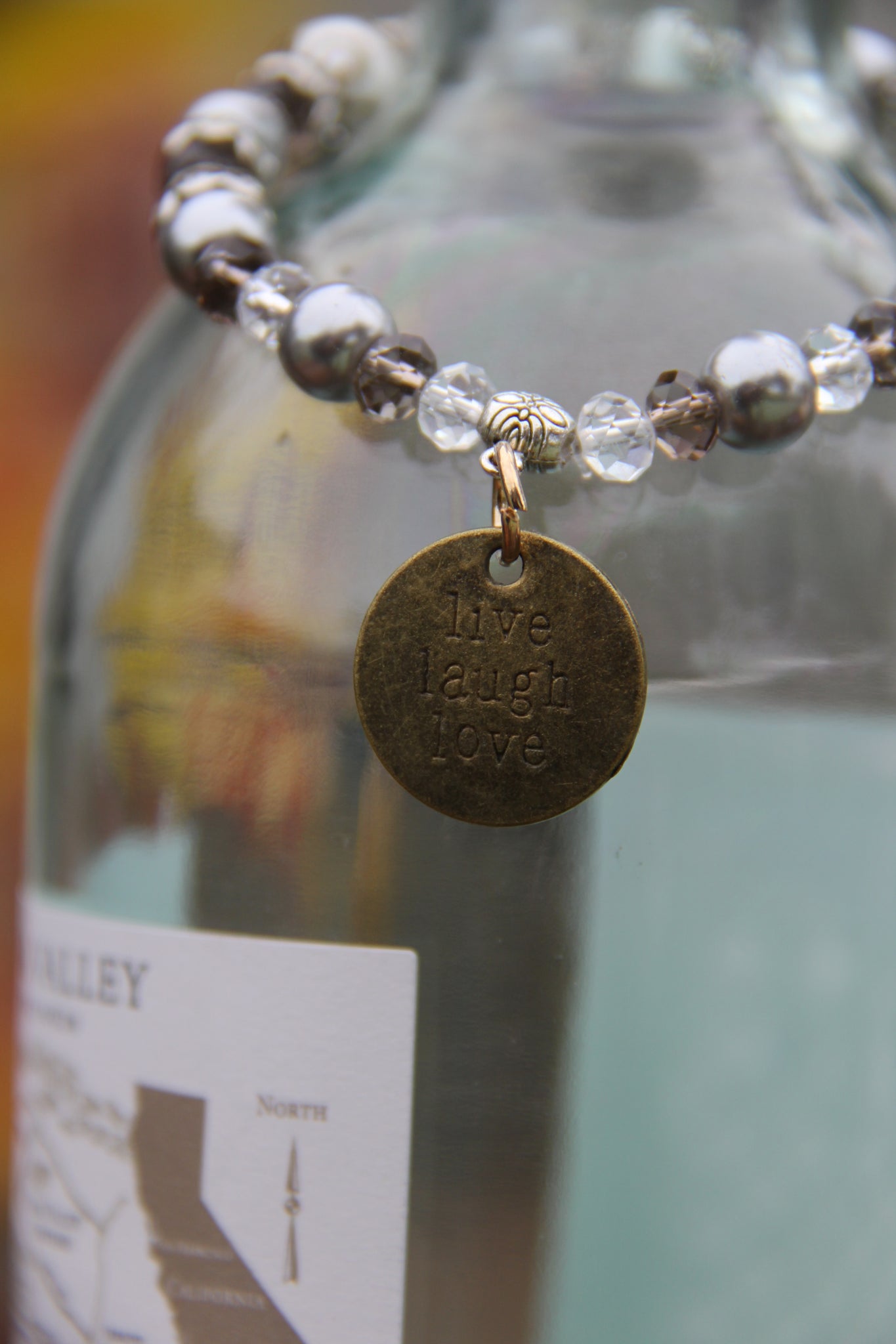 Bottle bracelet made with Grey glass beads with "live laugh love" charm