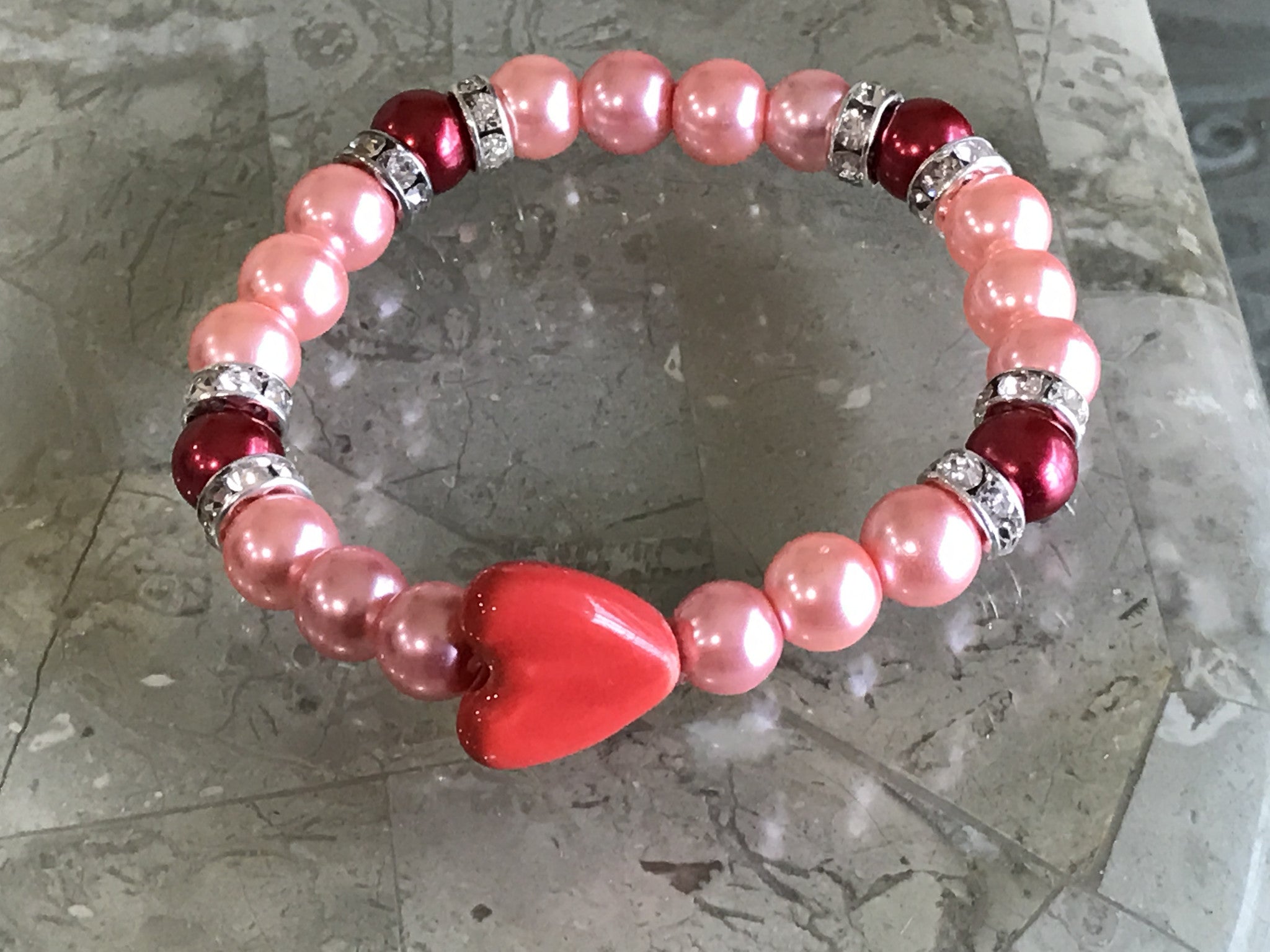 Pink pearl glass beads with red ceramic heart charm