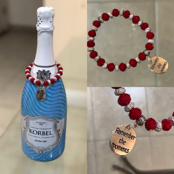 Red rondelle beads bottle bracelet with "Remember the moments" silver charm.